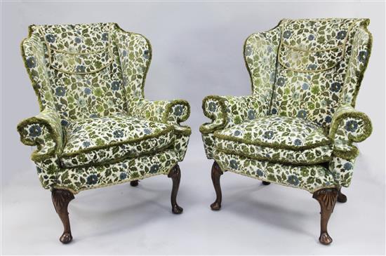 A pair of Queen Anne style wingback armchairs,